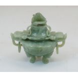 A modern Chinese green hardstone censer and cover, with ring and dragon-head handles, 14cm high,