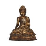 A large Burmese gilt-lacquered bronze figure of Shakyamuni Buddha, late 18th century, cast seated in