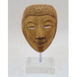 A Balinese carved wood mask, early to mid-20th century, mounted on perspex stand, 29cm highPlease