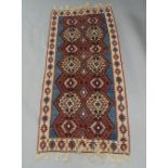 A Kilim runner, 20th century, geometric design on a red, blue and cream ground, 216 x 98cmPlease