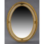 An Italian oval giltwood mirror, 20th century, with bevelled plate and incised cream painted border,