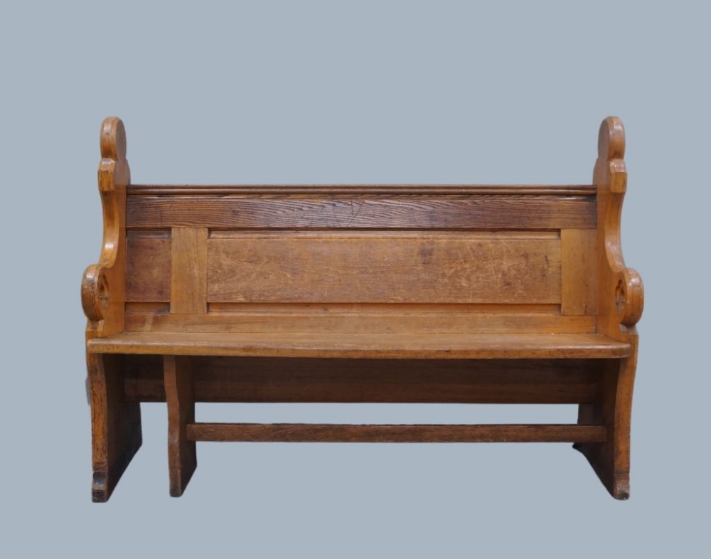 A pitch pine church pew, early 20th century, with carved armrests and painted with the number 93,