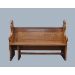 A pitch pine church pew, early 20th century, with carved armrests and painted with the number 93,