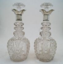 A pair of cut glass decanters and stoppers with silver collars, Sheffield, 1924, probably Walker &