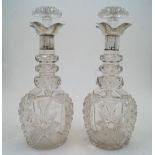 A pair of cut glass decanters and stoppers with silver collars, Sheffield, 1924, probably Walker &