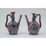 A near pair of Chinese porcelain ewers, 19th century, lacking covers, with knopped necks, curved