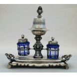 A Continental white metal inkstand, with bell on stand to centre with elaborate scrolling knopped