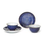A pair of Chinese powder blue ground tea cups and saucers, 18th century, the saucer painted in