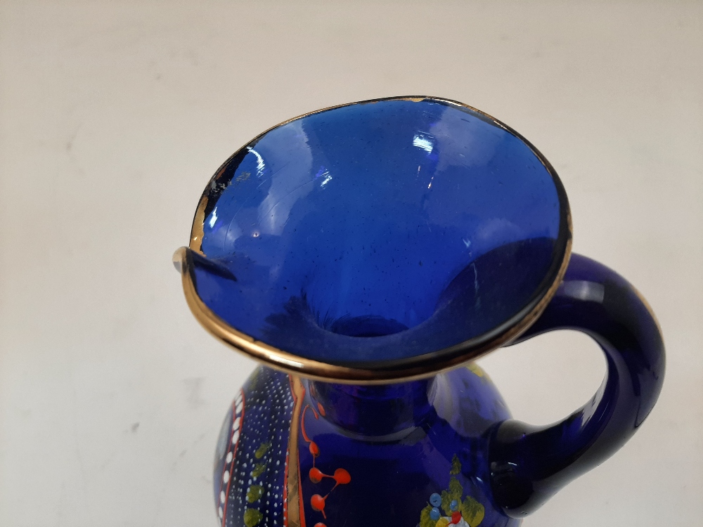 A Bohemian blue glass jug, 19th century, the body enamelled and gilded with foliate motifs and - Image 4 of 5