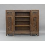 A Chinese hardwood inverted breakfront bookcase, early 20th century, with central open shelves