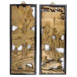 A pair of Chinese giltwood panels, early 20th century, carved with ladies walking in landscapes,