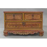 An Indian painted teak low chest of drawers, early 20th century, two short over one long drawer,