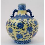 A modern Chinese underglaze blue and yellow ground 'scrolling lotus' bellied vase with iron red