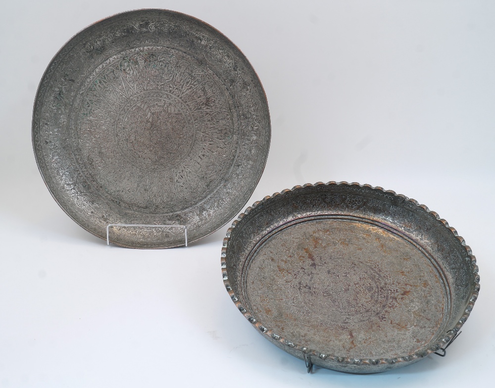 Two Qajar tinned copper dishes, late 19th / early 20th century, each elaborately chased with foliate