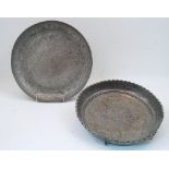 Two Qajar tinned copper dishes, late 19th / early 20th century, each elaborately chased with foliate