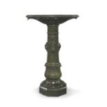 A green serpentine marble pedestal column, late 19th century, the shaped plateau with acanthus