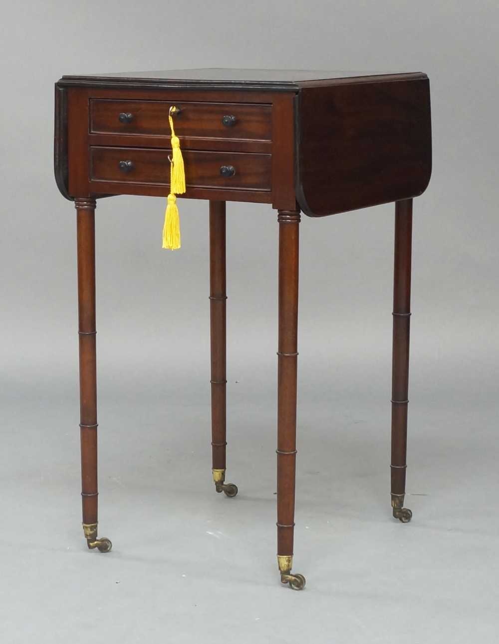 A late 19th century mahogany Pembroke table, of diminutive proportions, with two drawers and two