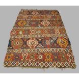 A kilim long rug, early 20th century, multi coloured geometric design, 310cm x 199cmmany rips all