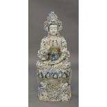 A large Chinese porcelain blue and white figure of Guanyin, 20th century, seated cross-legged on a
