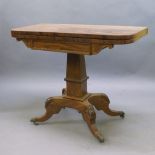 A Regency mahogany fold over tea table, the rectangular top with rounded edges, above trapezium