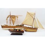 Three model wood boats, 20th century, comprising: a multi-sail yacht with moveable rudder, 50cm