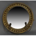 A giltwood and gesso convex mirror, 19th century, with later added candle sconces, 46cm
