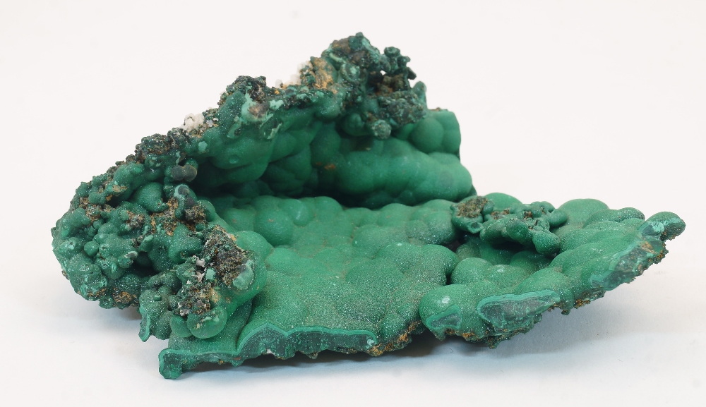 A specimen of malachite, of natural form, 12cm wideThis specimen is in it natural raw state. It