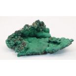A specimen of malachite, of natural form, 12cm wideThis specimen is in it natural raw state. It