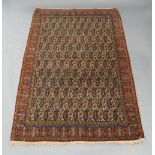 A Persian Senneh rug, 20th century, central repeating paisley design on a cream ground, contained by