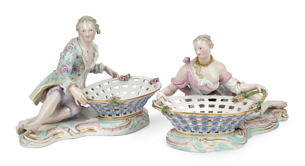 A pair of Meissen porcelain figural sweetmeat baskets, late 19th century, blue crossed swords marks,