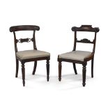 A harlequin set of eight William IV rosewood dining chairs, to include a set of four with carved