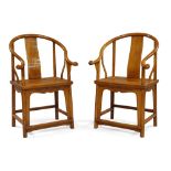 A pair of Chinese horseshoe-back wood chairs, quanyi, late Qing dynasty, the top rail slopping