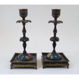 A pair of Chinese cloisonne brass candlesticks, 20th century, the scalloped drip pans atop double