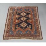 A Caucasian rug, 20th century, triple diamond medallion on a red and blue ground, contained by