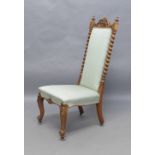 A Victorian walnut side chair, with carved and pierced crest, flanked by turned finials above barley