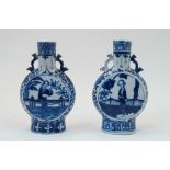 A pair of Chinese blue and white porcelain moon flasks, 19th century, each with twin ruyi sceptre