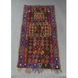 A Kilim rug, early 20th century, geometric design on a multi coloured ground, 180cm x 90cmloss of