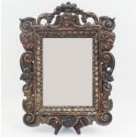 An Italian style carved oak mirror, early 20th century, the rectangular plate within a floral scroll