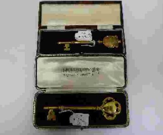 A silver-gilt presentation key, London, 1936, Hicklenton & Phillips, 11.5cm, surmounted with
