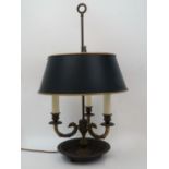 A French brass bouillotte lamp, 20th century, the three branches modelled as griffin heads issuing