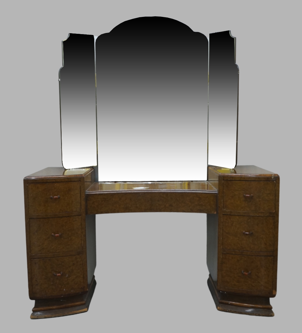 An Art Deco burr walnut dressing table, with triptych mirror above central long drawer flanked by