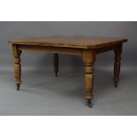 A Victorian mahogany wind out dining table, raised on turned supports and castors, 75cm high,