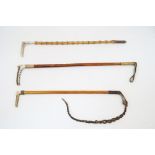 Three horn handled riding crops, 20th century, to include an example with fruitwood shaft and 9