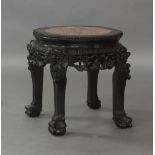 A Chinese black lacquered hardwood jardiniere stand, 20th century, inset with marble, raised on