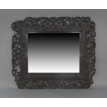 An Anglo-Indian stained teak mirror, early 20th century, carved and pierced floral border, 74cm x