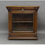 A Victorian carved pussy oak pier cabinet, single drawer flanked by two carved lion heads, above