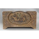A Chinese camphor chest, 20th century, carved with scenes of Chinese junks, figures and dragons,