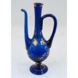 A Bohemian blue glass ewer, 19th century, the body with gilt highlights and gilded grape and vine