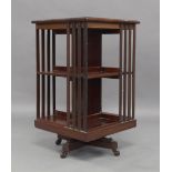 An Edwardian mahogany revolving bookcase, raised on castors, 82cm high, 48cm wide, 48 cm deeplegs