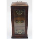 A Victorian walnut table top cabinet, late 19th century, the door with beveled glass enclosing three